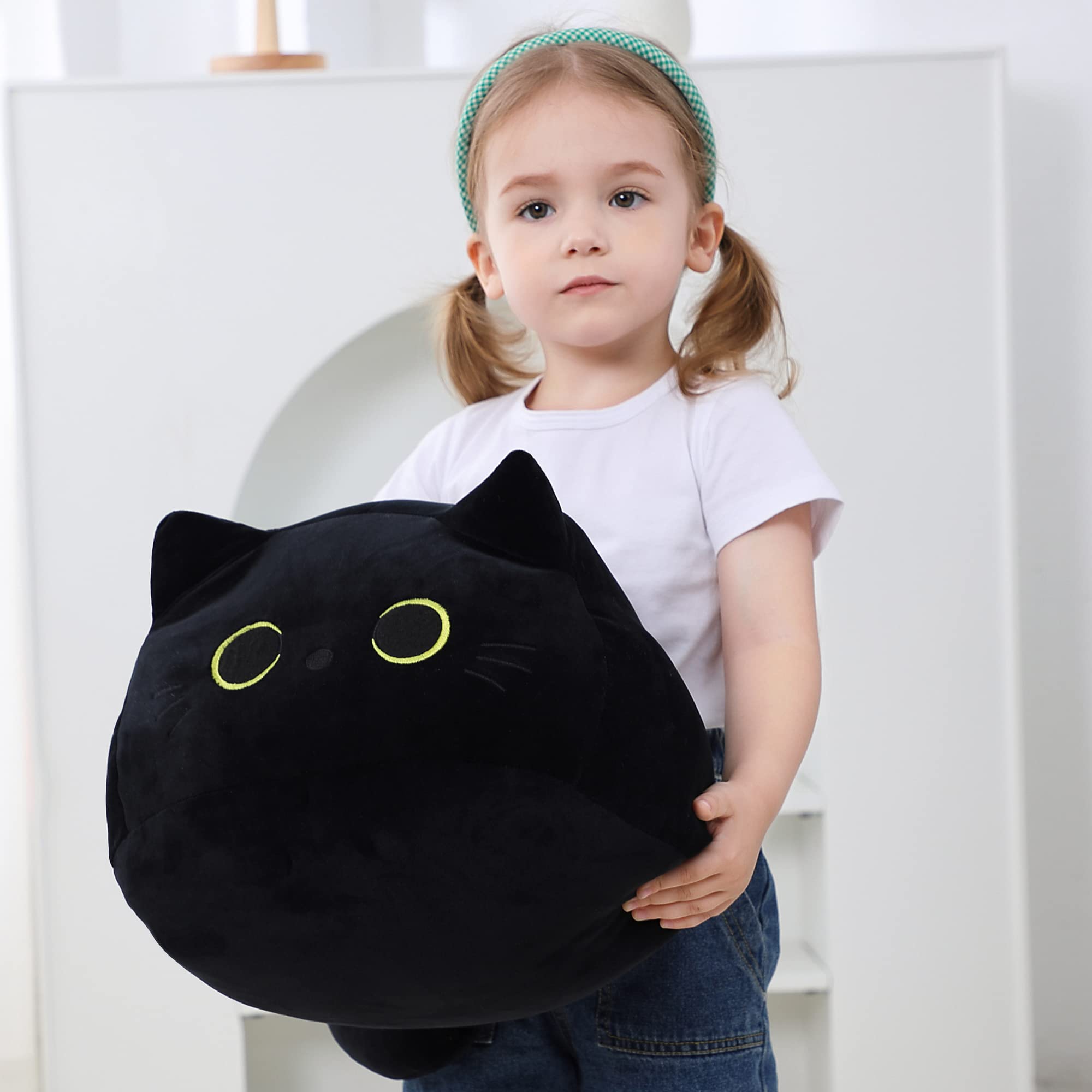 WeBingo Black Cat Plush provides gentle nap support on couch.
