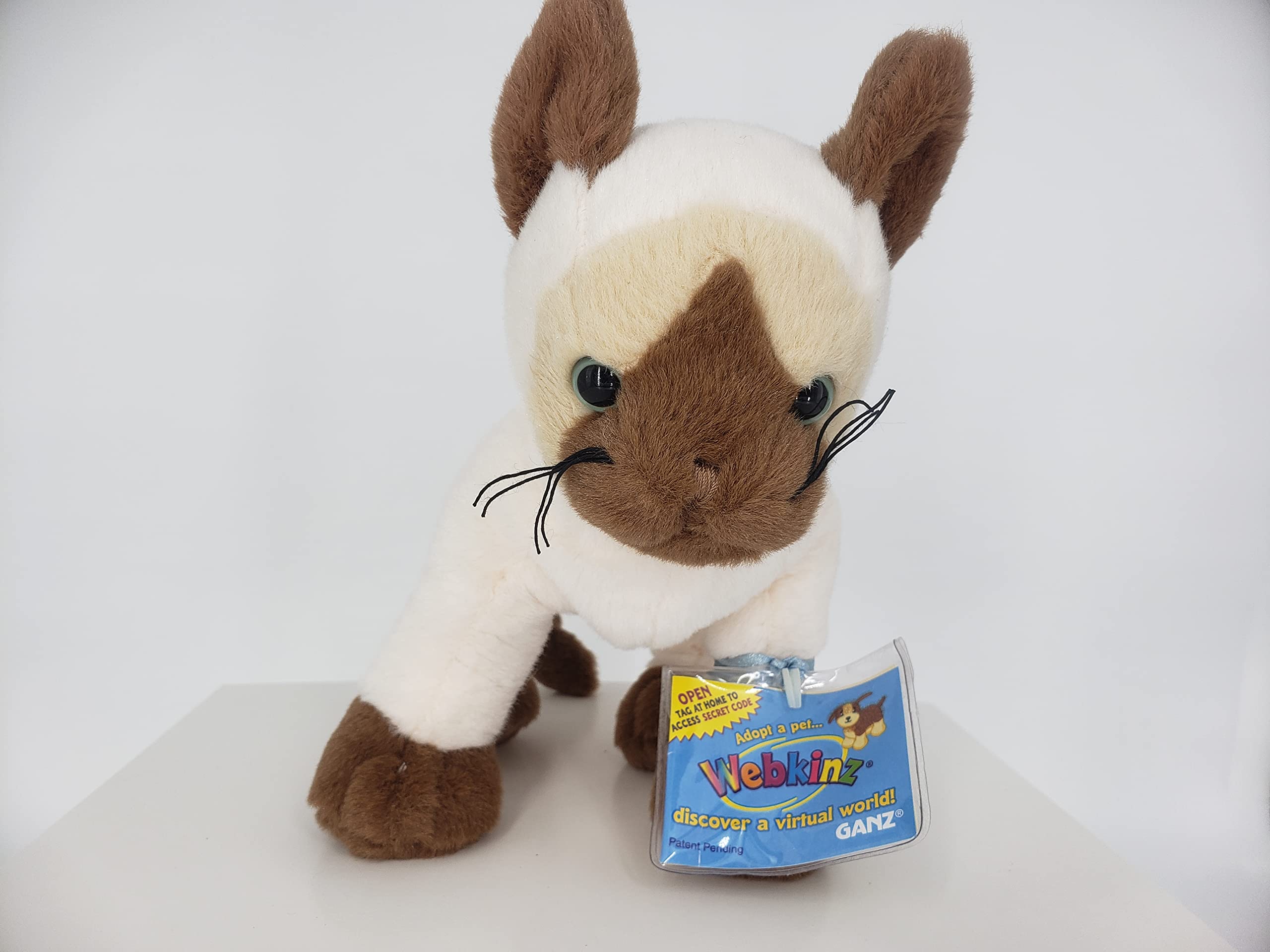 Webkinz Siamese Cat unlocks Webkinz World with code for online play.