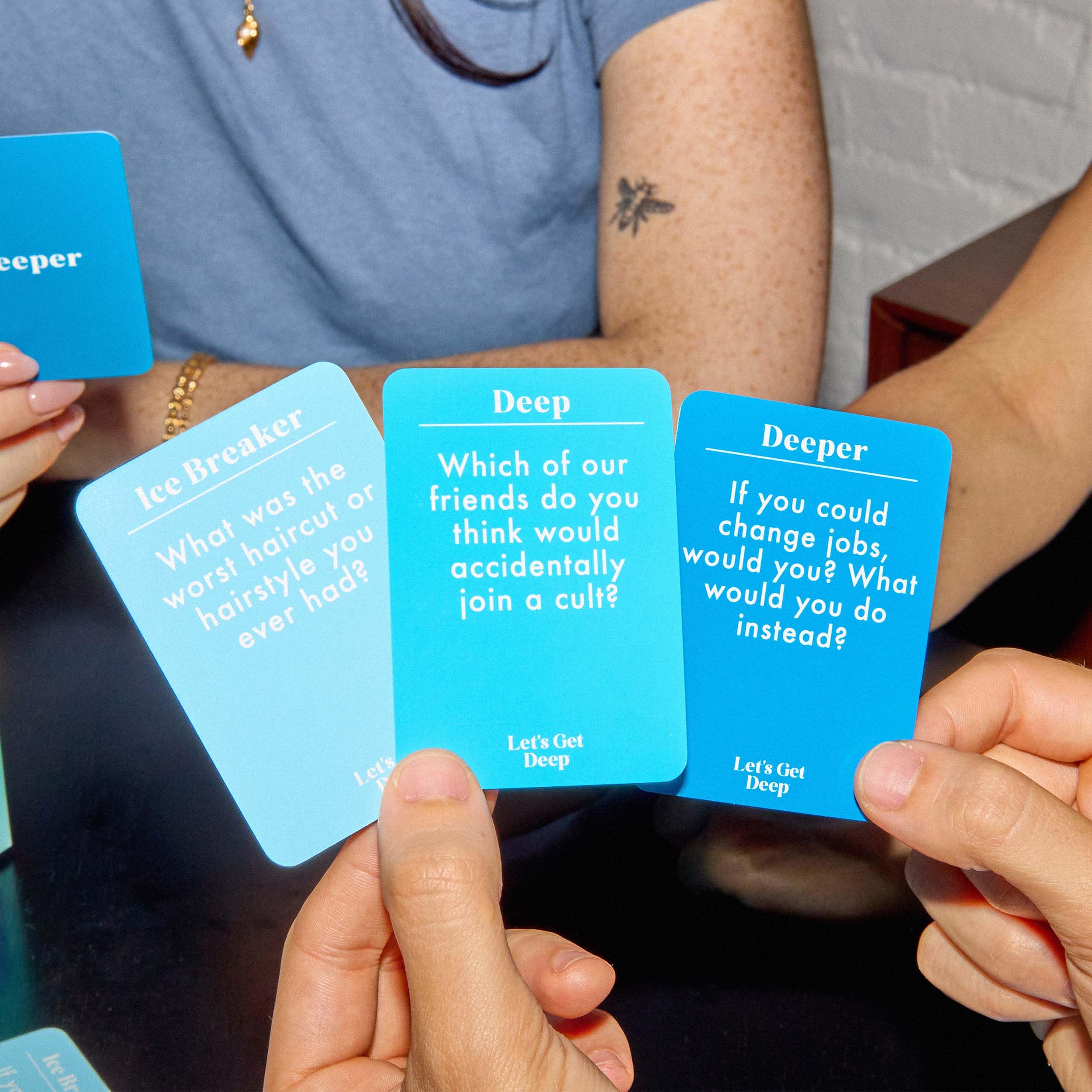 WHAT DO YOU MEME? Let’s Get Deep Ice Breaker cards on display sparking quick chats