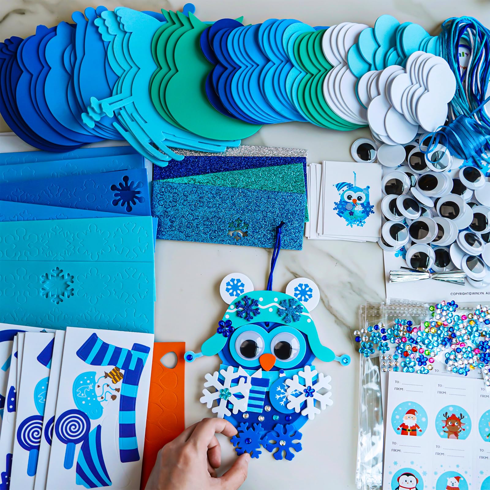Winlyn beak-stickers provide precise facial features for expressive ornaments.