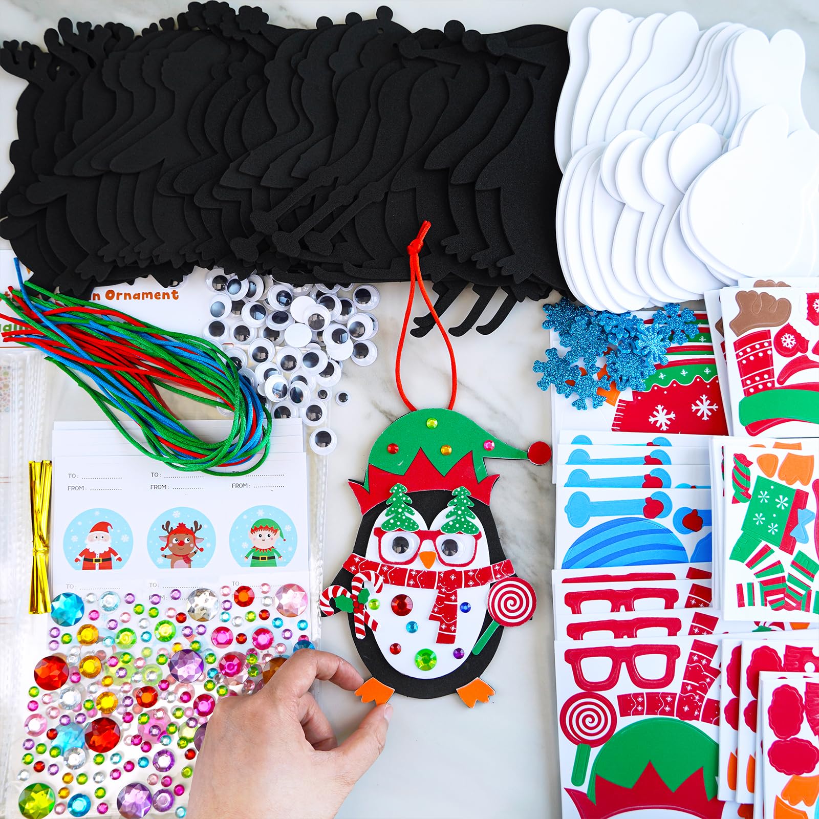Winlyn glitter snowflake stickers add festive sparkle to penguin crafts.