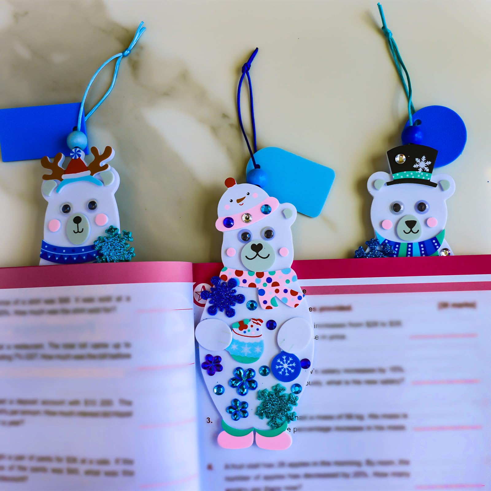 Winlyn polar bear bookmark kit shows kids applying colorful holiday stickers for creative projects.