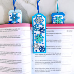 Winlyn satin cords and silver twist ties enhance bookmark finishing.