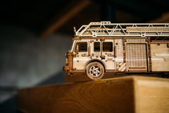 Wood Trick Rescue Firetruck spring motor powers dynamic movement demonstrations.