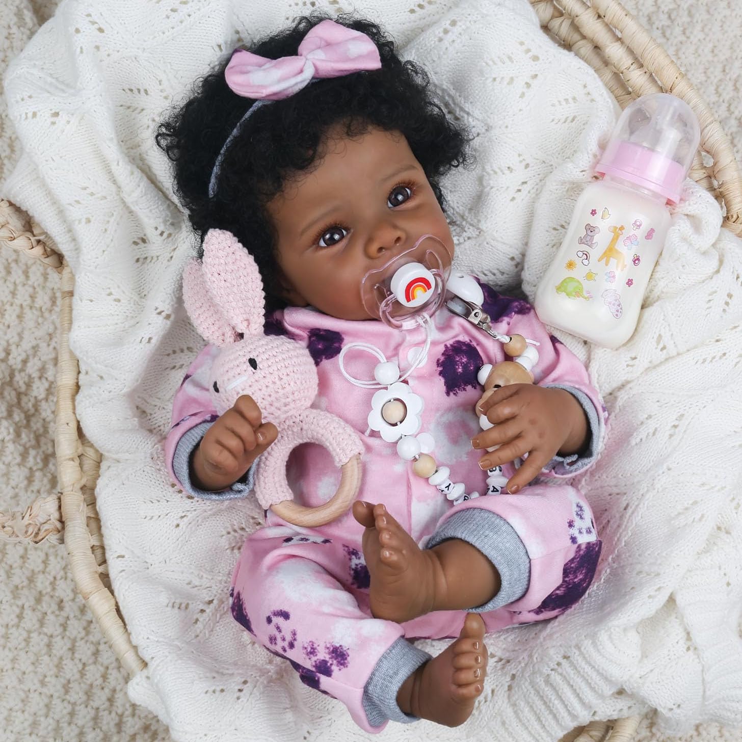 WOOROY Realistic Reborn Baby Doll Black Girl in pink jumpsuit promotes imaginative play.