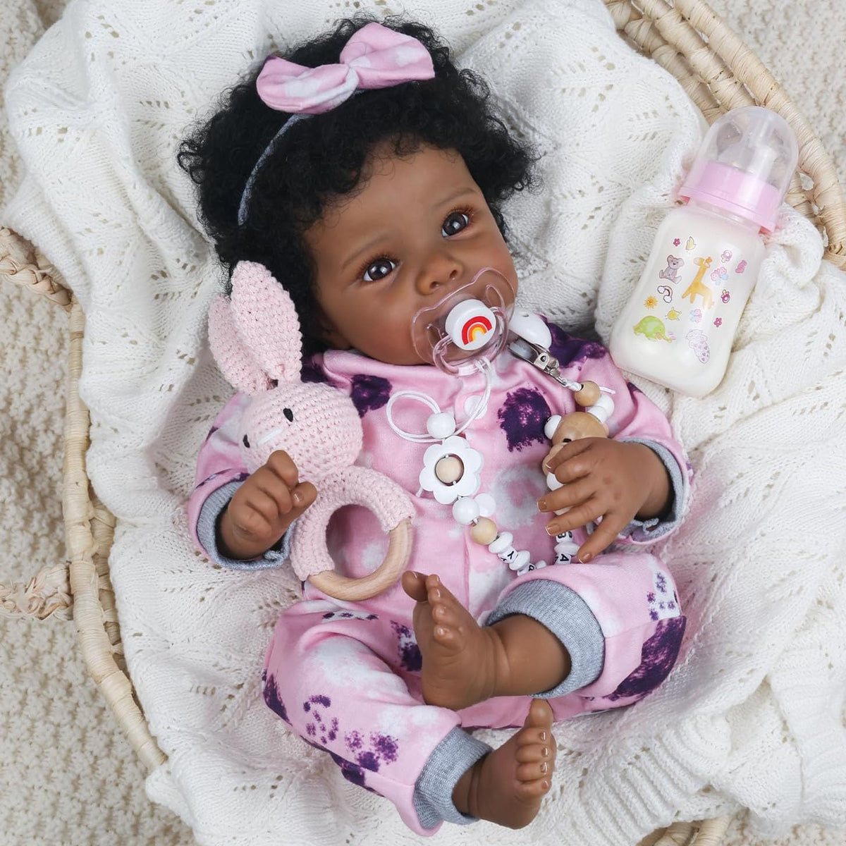 WOOROY Realistic Reborn Baby Doll Black Girl in pink jumpsuit promotes imaginative play.