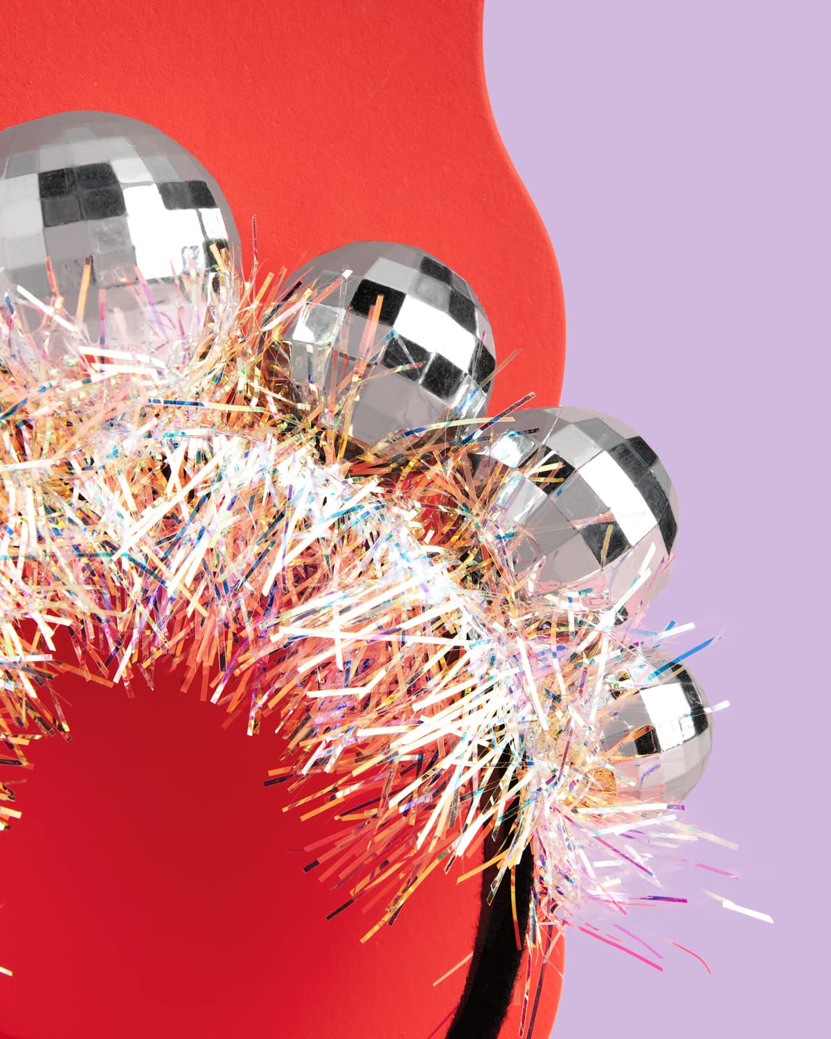 xo Fetti disco ball headband worn by an adult shows versatile sizing.