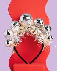 xo Fetti disco ball headband worn by a child highlights comfortable, adjustable fit.