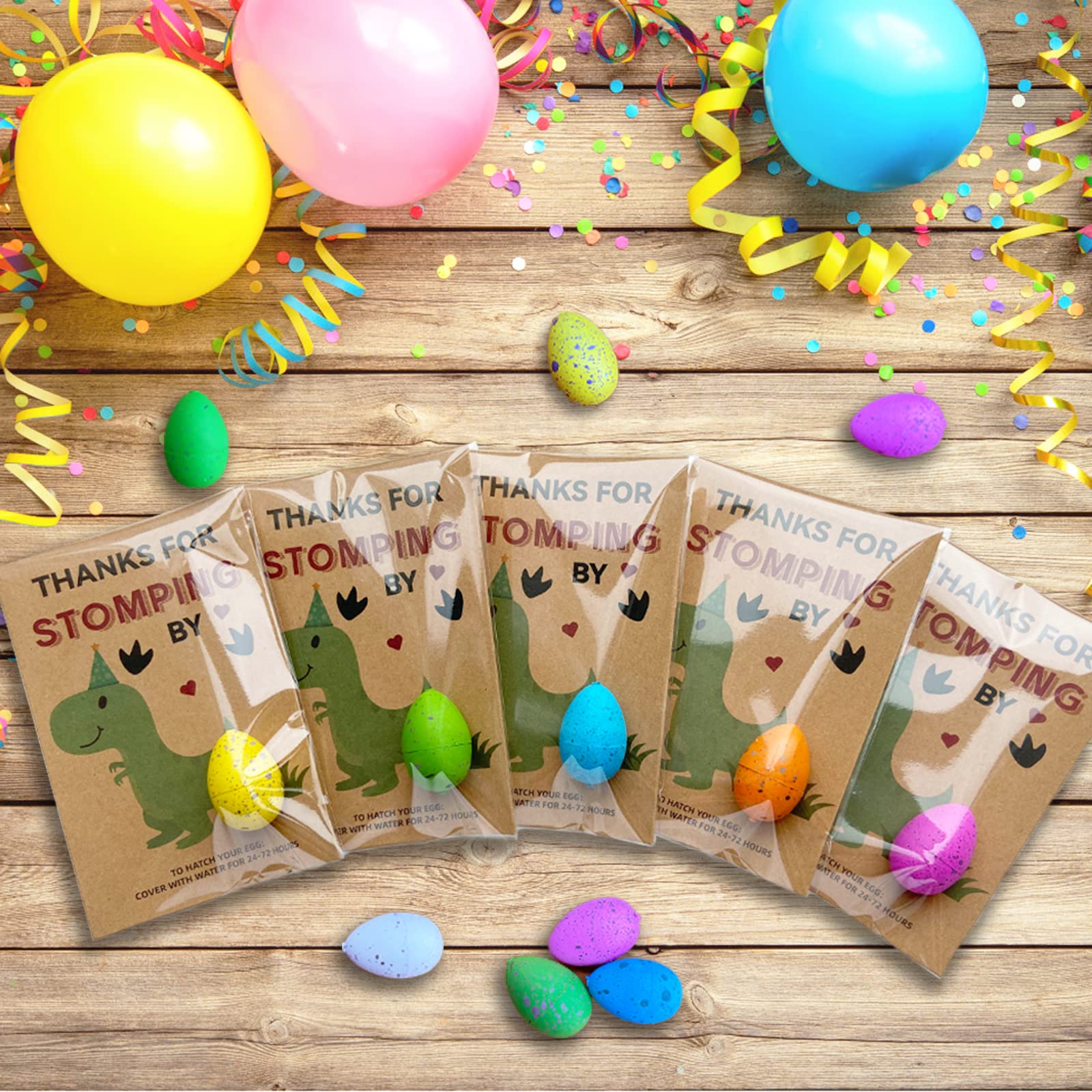 Y_Bong dinosaur party favors showing eggs and colorful cards.