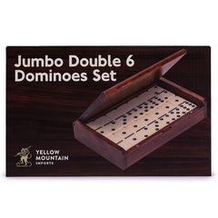 Hands stacking domino tiles to demonstrate handling and weight