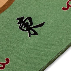 Non-slip rubber-backed table cover securing game setup during play.