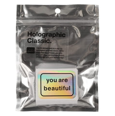 You Are Beautiful stickers on a laptop displaying hopeful messages