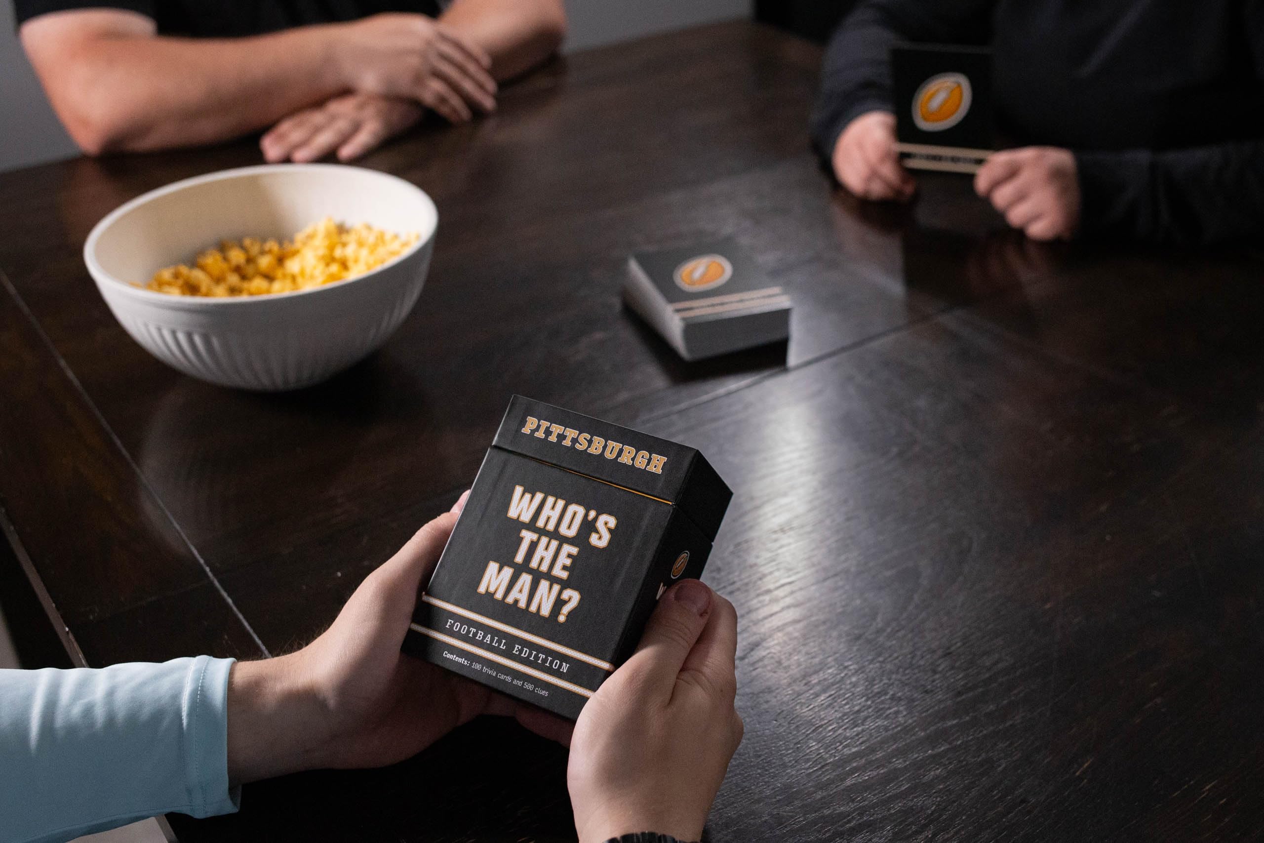 You Gotta Know's Who's the Man? game-night-setup invites groups to reminisce and bond.