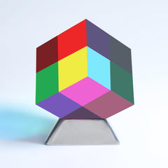 YuanDian CMY Cube with Stand on a desk showing vibrant color mixing.